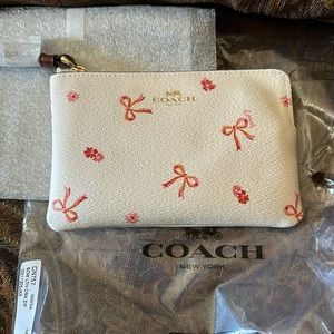 Coach wristlet bow print corner zip please trade for Star Wars one. New